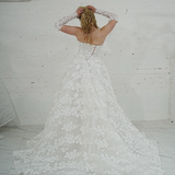 romantic white ballgown adorned with floral lace and enchanting 3D floral details.