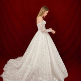 ballgown wedding dress with floral lace and elegant off-shoulder sleeves.