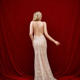 Ethereal ivory and white gown with floral embellishments and a dramatic thigh-high slit.