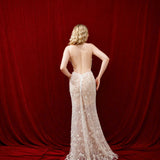 Ethereal ivory and white gown with floral embellishments and a dramatic thigh-high slit.