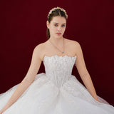 sparkling white ballgown with a sculpted corset and enchanting 3D details.
