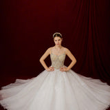 white ballgown featuring sparkling floral embellishments and an elegant corset silhouette.