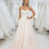 White flowery Bustier cup with a blush tulle skirt.