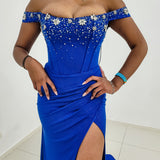 Sparkling jersey royal blue column shaped dress with crescent moon neckline and high slit for hire