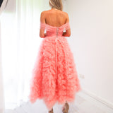 Pastel pink straight neck line with off the shoulder and tulle skirt up to the knees.