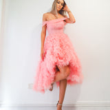 Pastel pink straight neck line with off the shoulder and tulle skirt up to the knees.