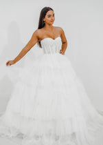 White wedding dress with a bushier top and a bushier puffy layered skirt for hire