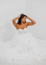 Rina white wedding dress with a bushier top and a bushier puffy layered skirt