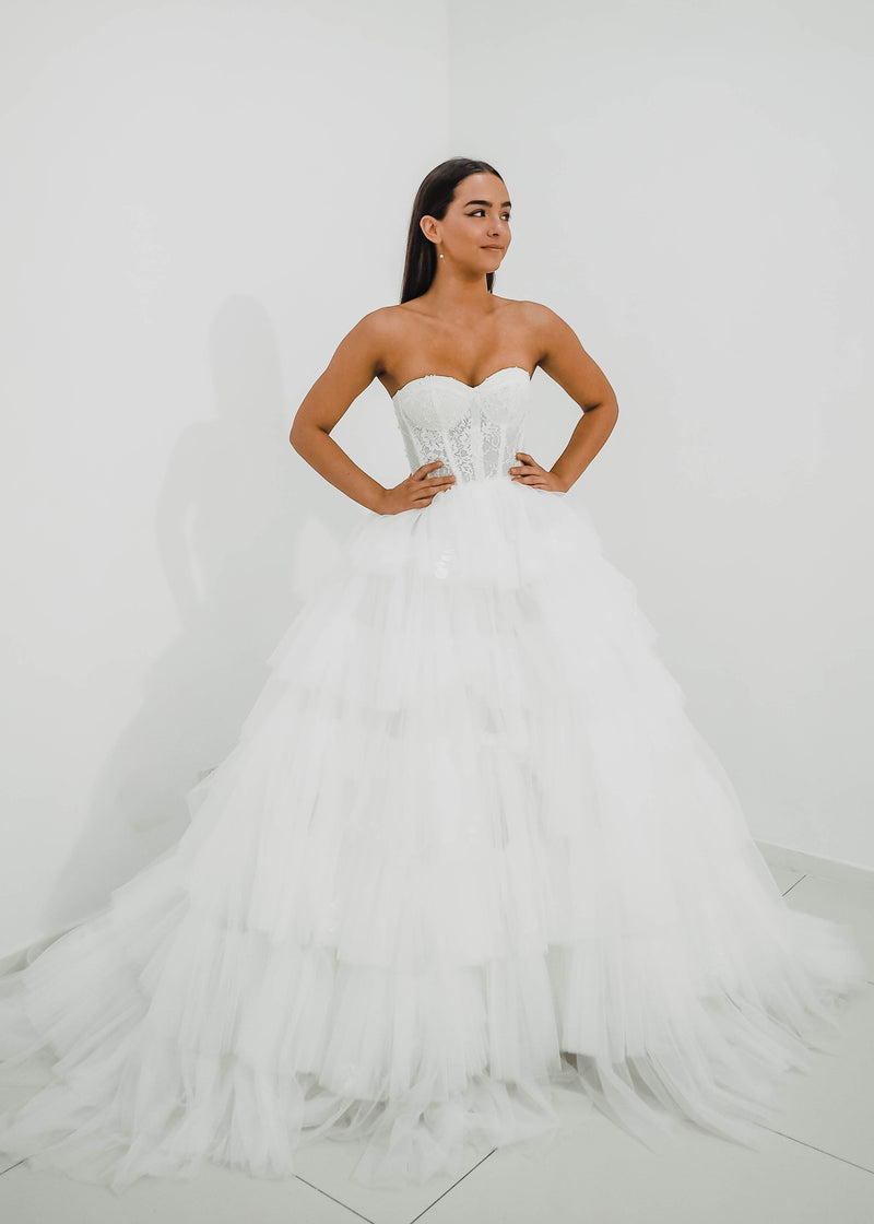 White wedding dress with a bushier top and a bushier puffy layered skirt for hire