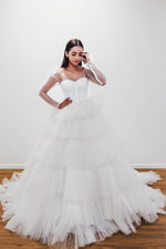 Winry white wedding dress with a bushier top and a bushier puffy layered skirt for hire