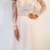 Pastel pink accent straight neck line with a pastel pink flowy skirt and long sleeves.
