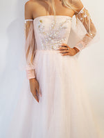 Pastel pink accent straight neck line with a pastel pink flowy skirt and long sleeves.
